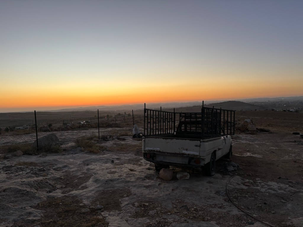 Sunset in Masafer Yatta. Truck in the foreground was torched in an attack by Israeli Settlers
